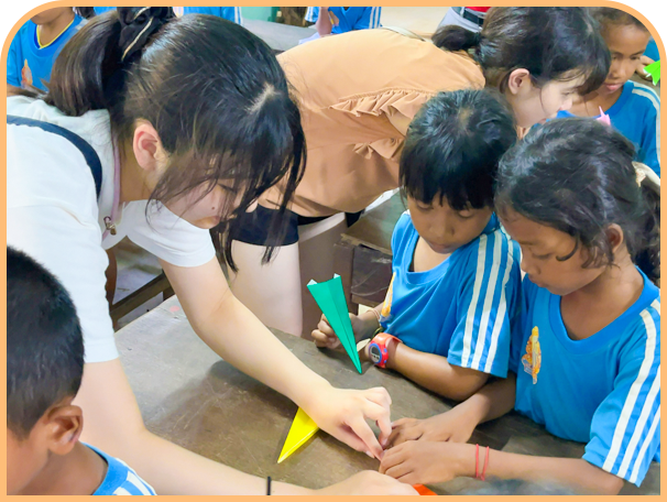 現地の小学生と折り紙体験。あまり英語が通じない中で一生懸命指導したとのこと